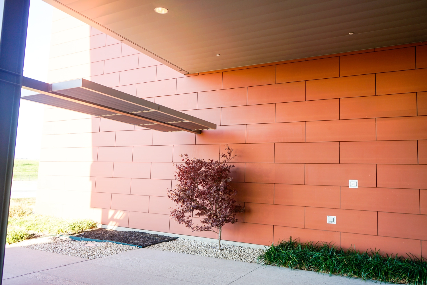 Building facade with red metal panels.