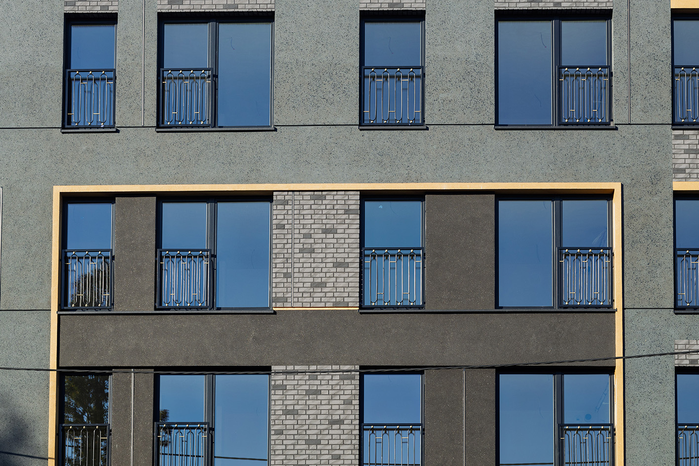 Black and gray façade of multi-story building.
