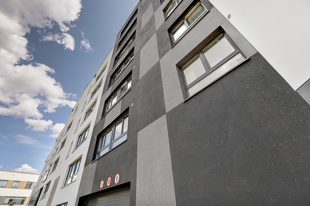 Gray and black specialty facade finishes on high-rise building.