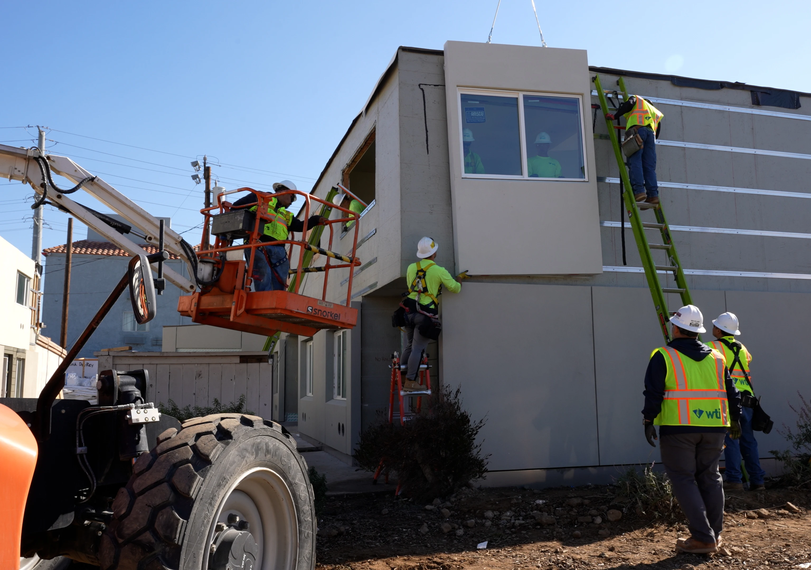 installers hanging exterior wall panel