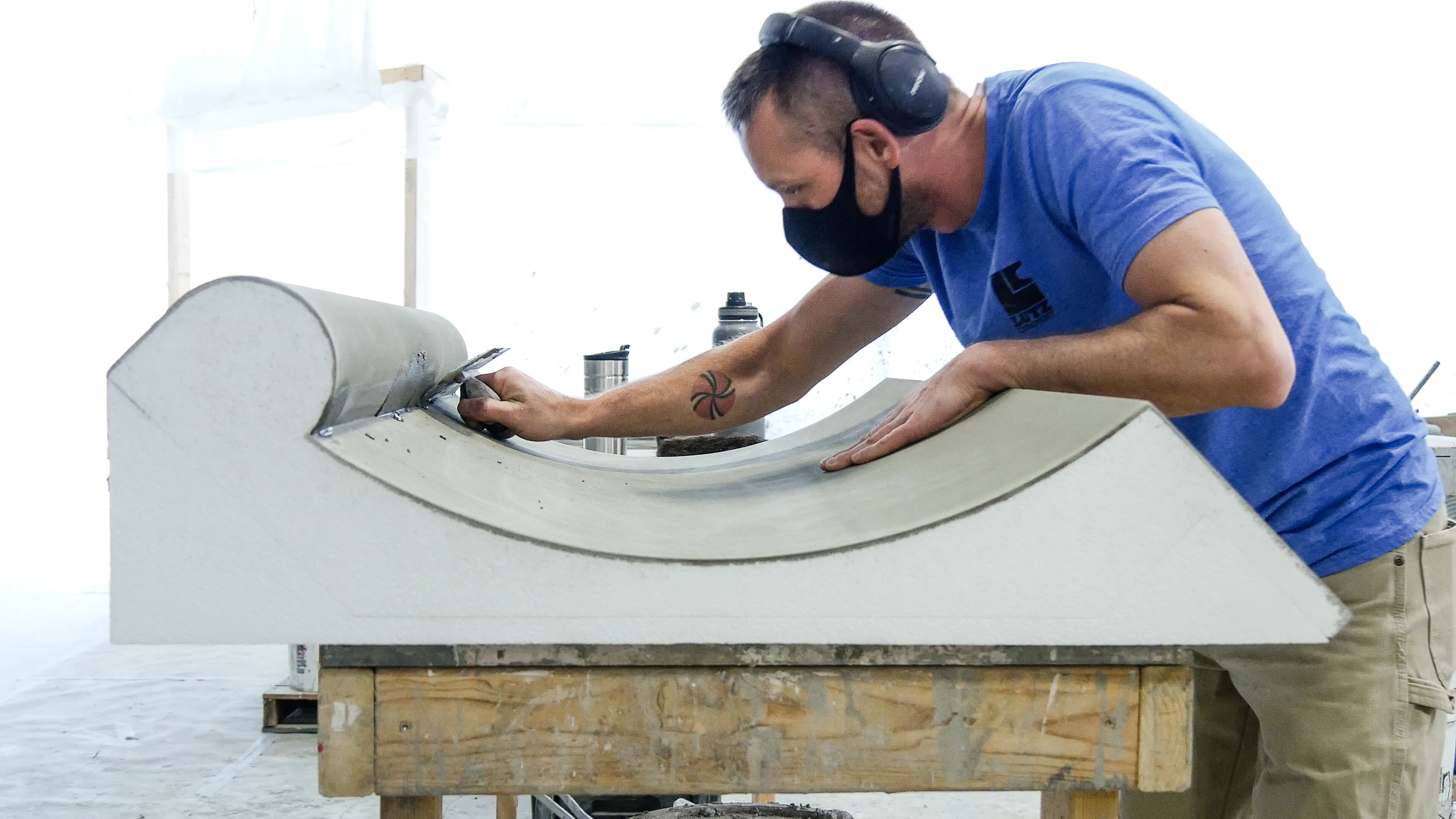 worker assembling wall accent in plant