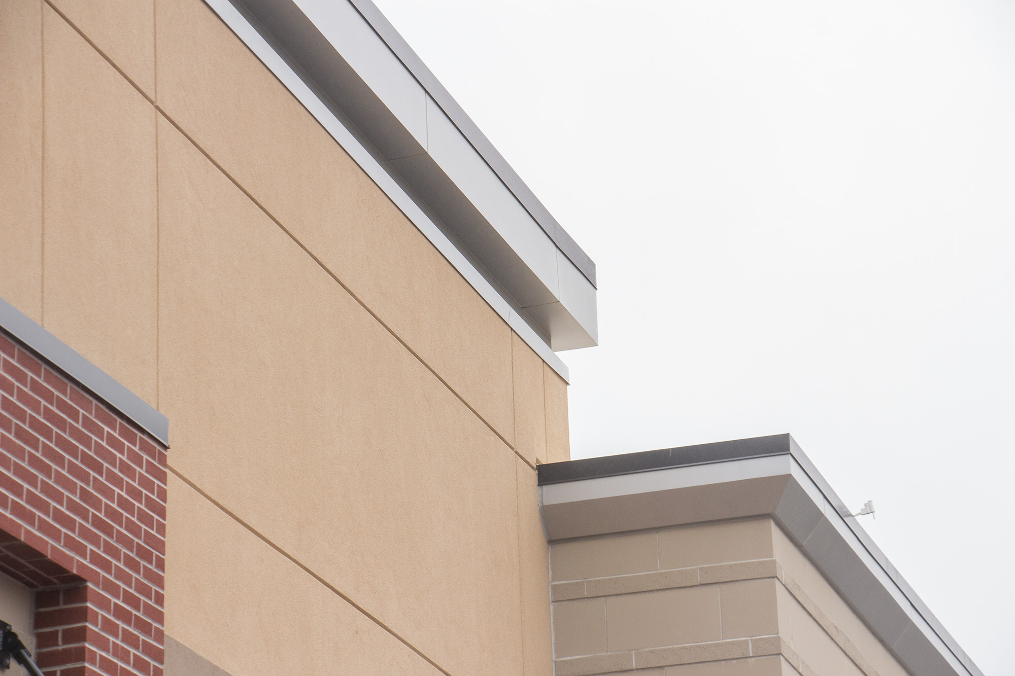 Metallic EIFS at roof condition.