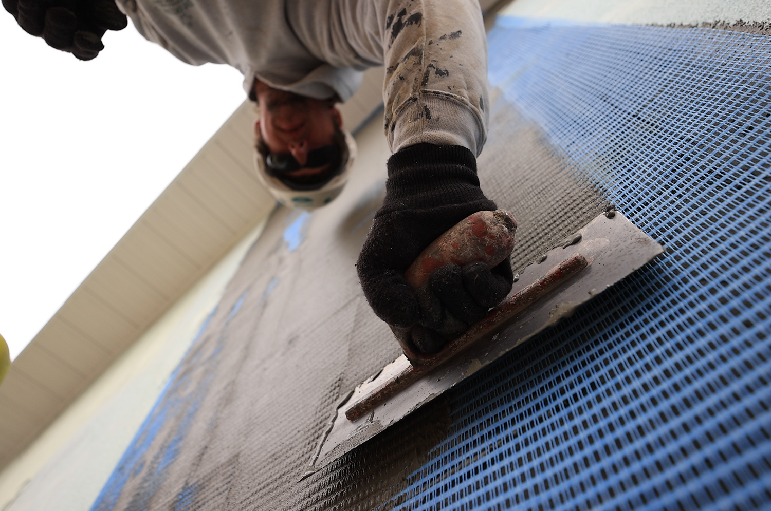 Installer applying StucCoat.