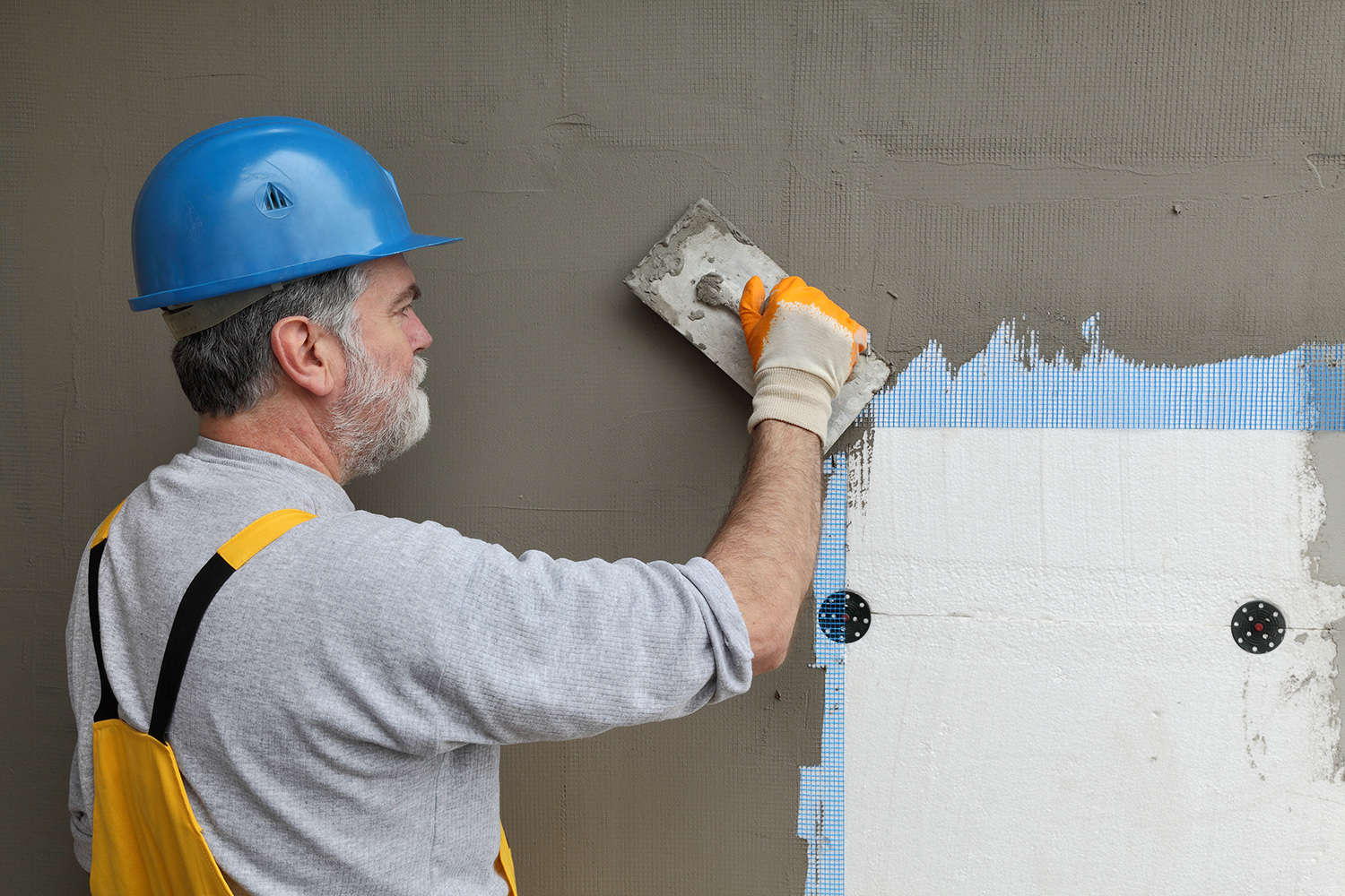 Worker installer traditional stucco.