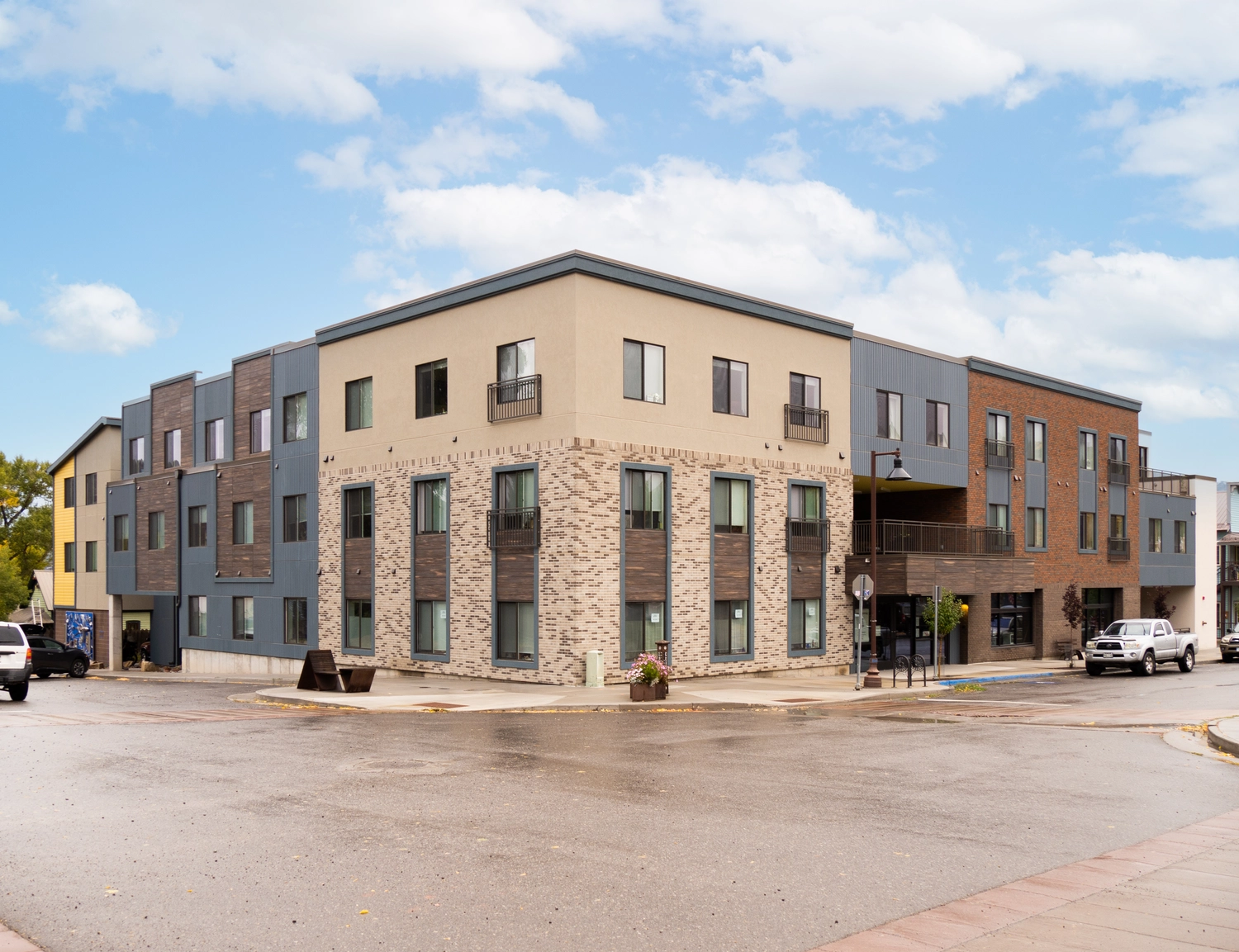 affordable housing building with brick, wood and stone exterior